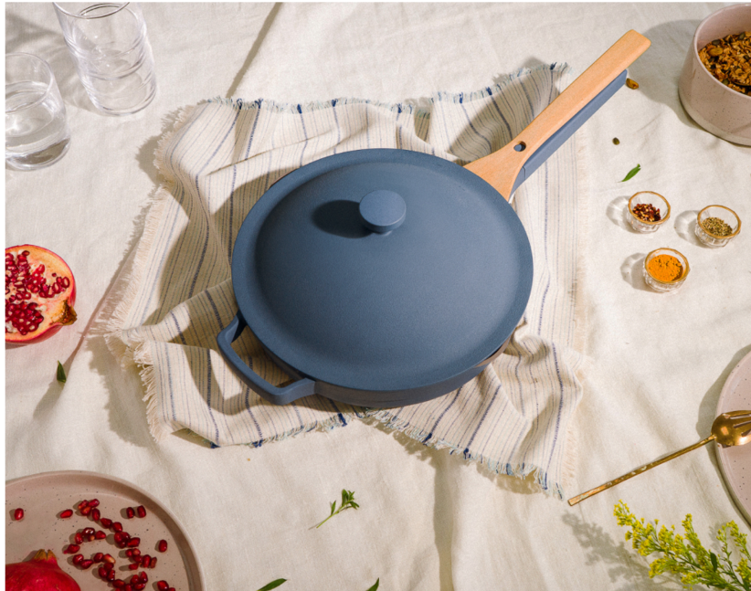 blue pan with beechwood spoon that fits neatly on handle half under the lid