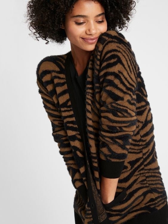 Model wearing the brown and black zebra print cardigan