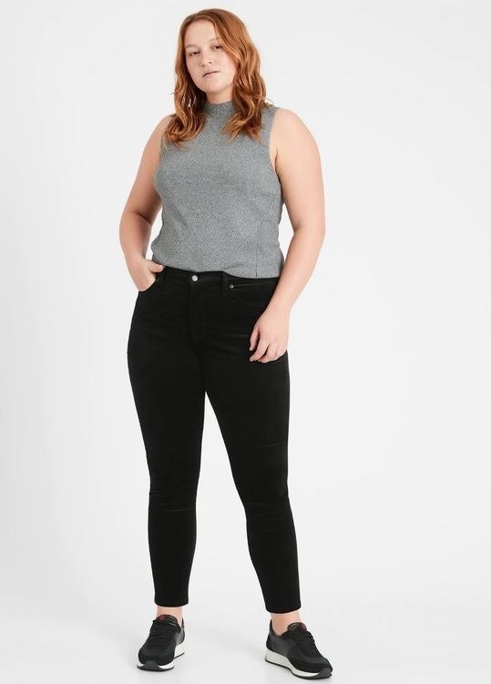 Model wearing the black velvet pants