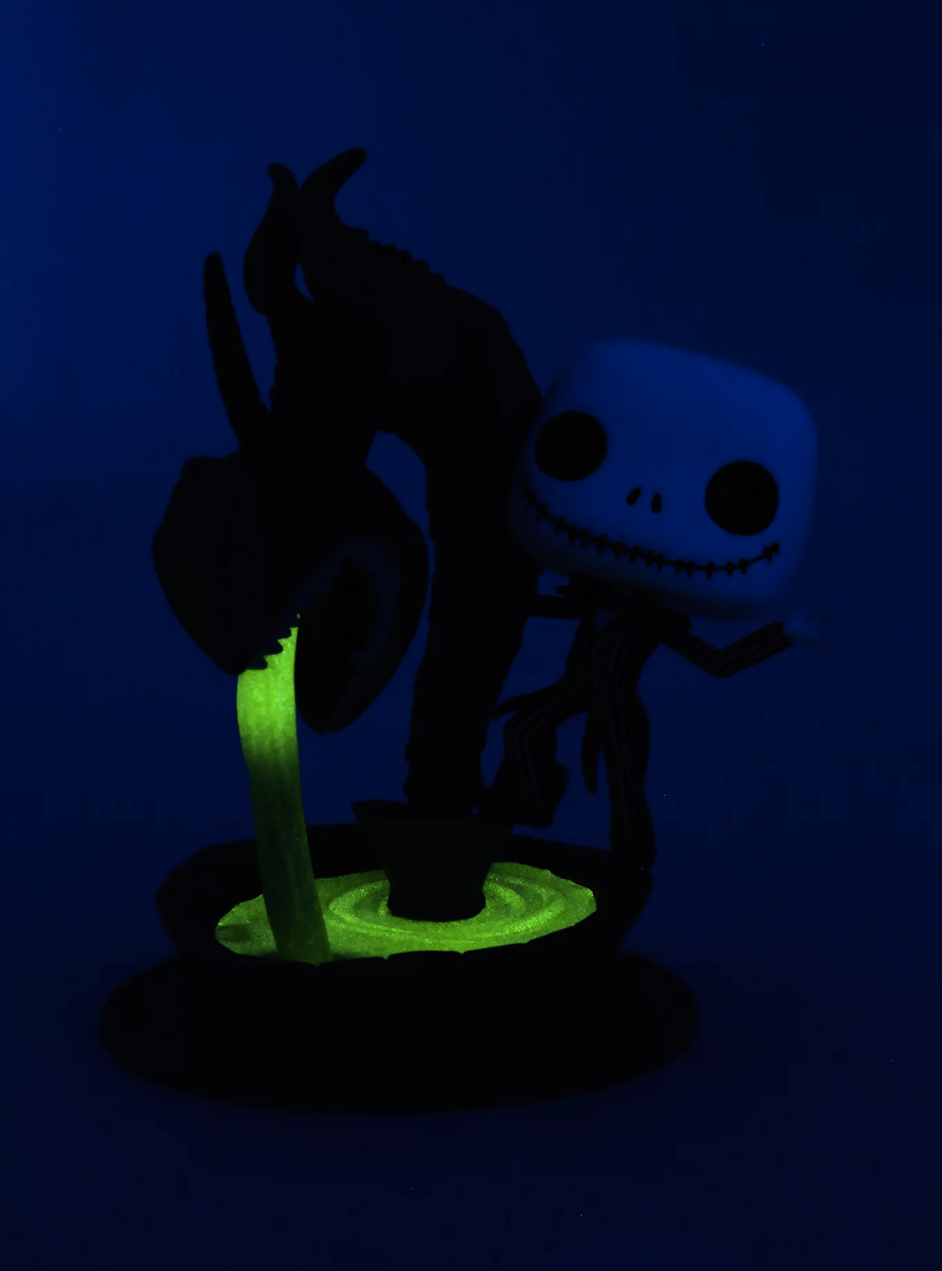 plastic figure that looks like jack hangs out with fountain that spits out glow in the dark liquid 