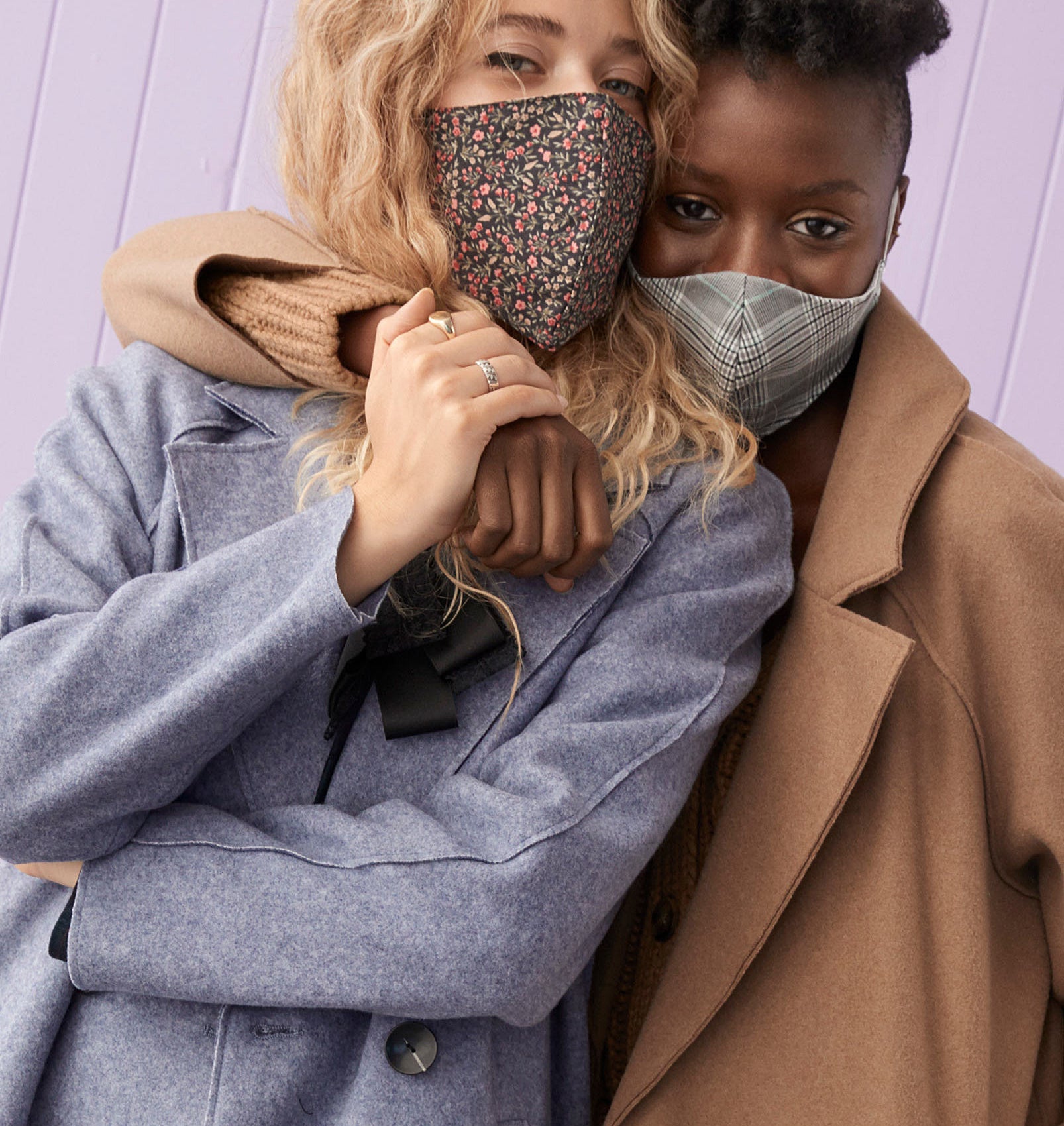 Two people wearing jackets and face masks