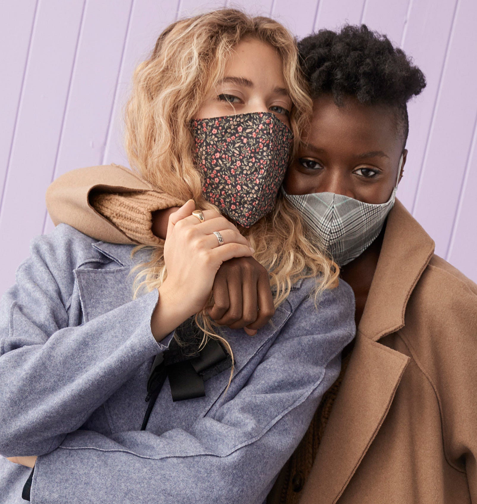 Two people wearing jackets and face masks