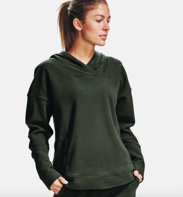 model wearing UA fleece hoodie in baroque green 