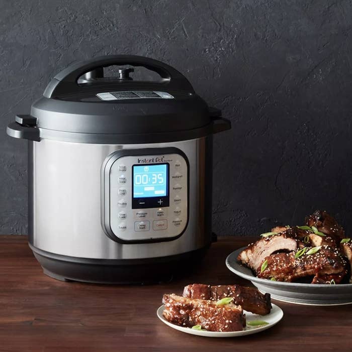 An Instant Pot with sticky ribs next to it 