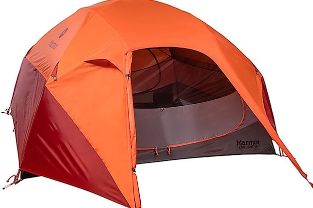 orange and red domed tent with a large zippered door and staked vestibule