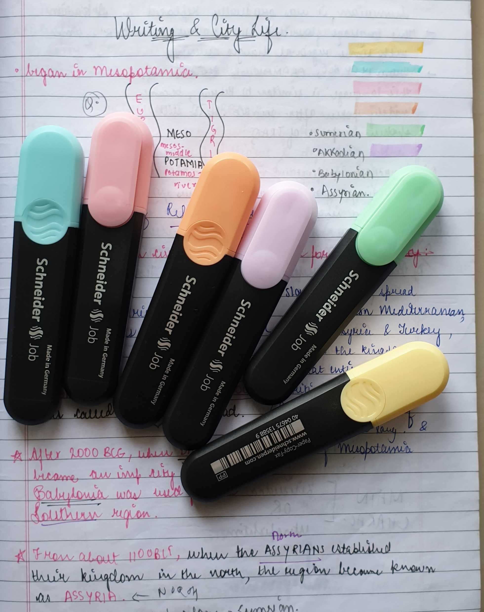 Image of 6 highlighters in various colours kept on a notebook page.