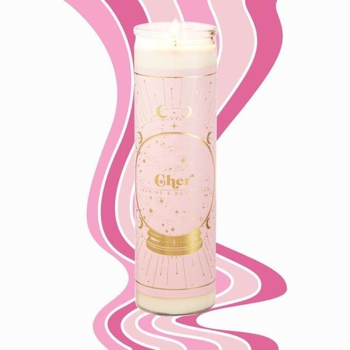 tall prayer-like candle with light pink label and gold detailing for Cher