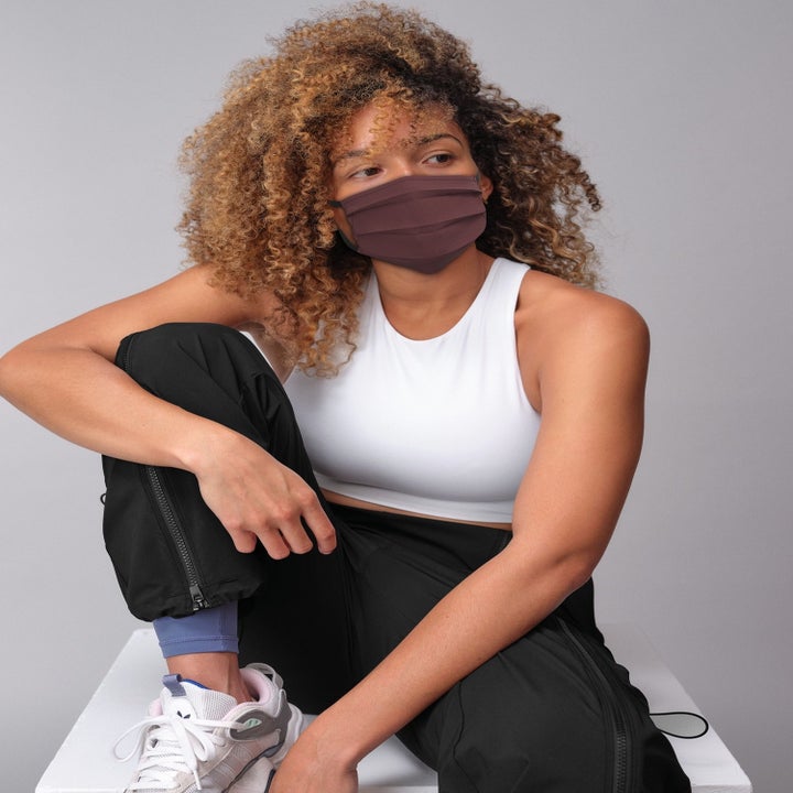 A model wearing one of the masks in brown