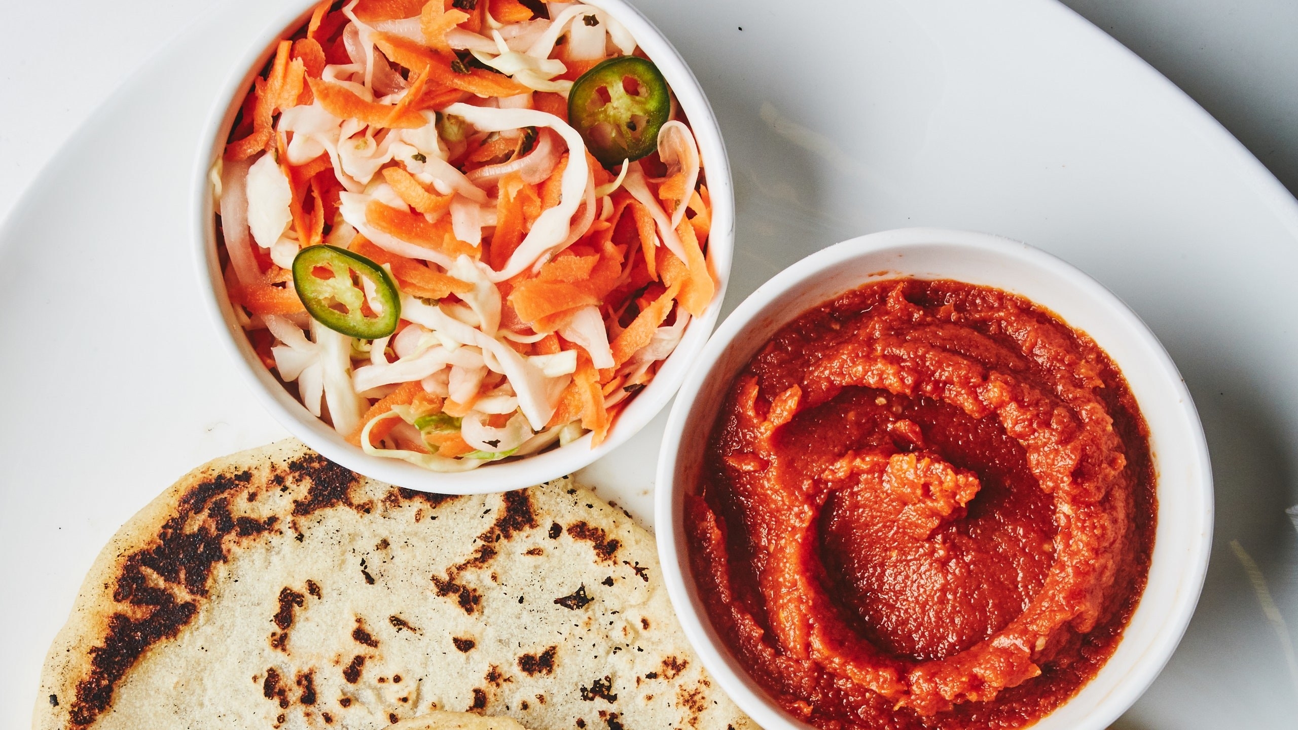 Bowl of curtido with pupusas