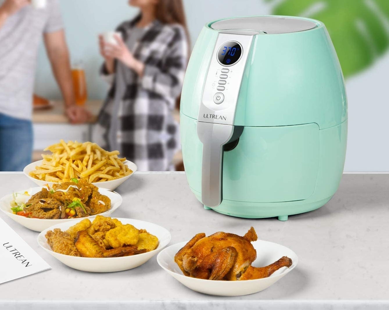 An air fryer surrounded by air fried foods