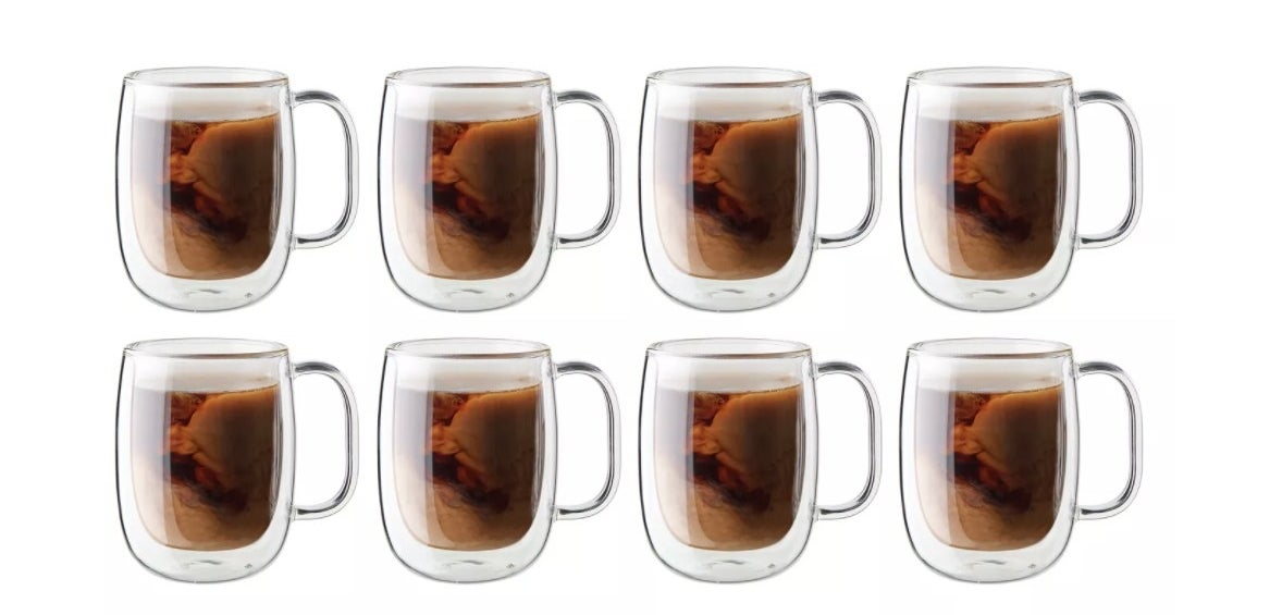 a set of 8 mugs with coffee inside of it