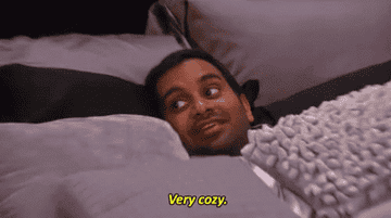 Tom Haverford from Parks and Rec bundled in blankets saying &quot;very cozy&quot;