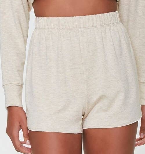 Model wearing the cream-colored shorts