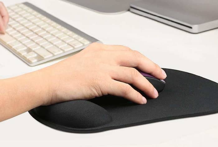 A hand resting on the mouse pad.