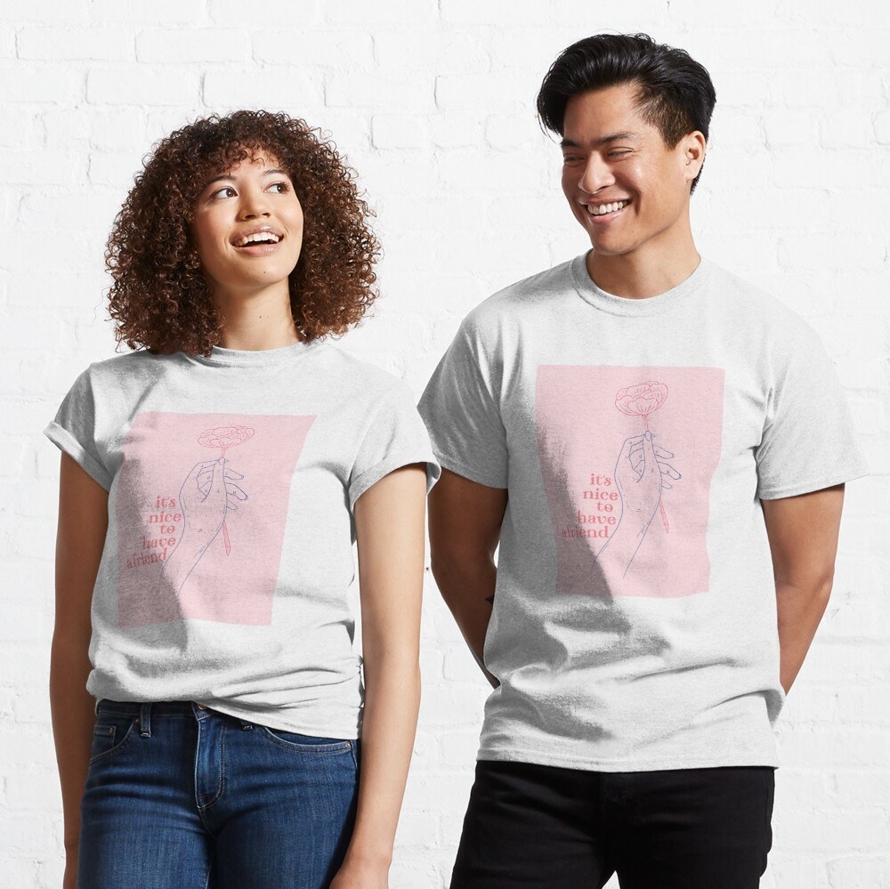 two models wearing white tees with a pink square on them, a hand holding a flower, and the quote &quot;it&#x27;s nice to have a friend&quot;