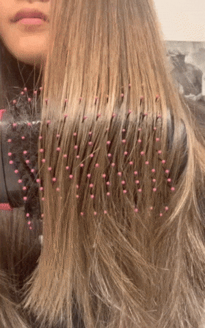 BuzzFeed writer using the hair dryer brush to taper ends