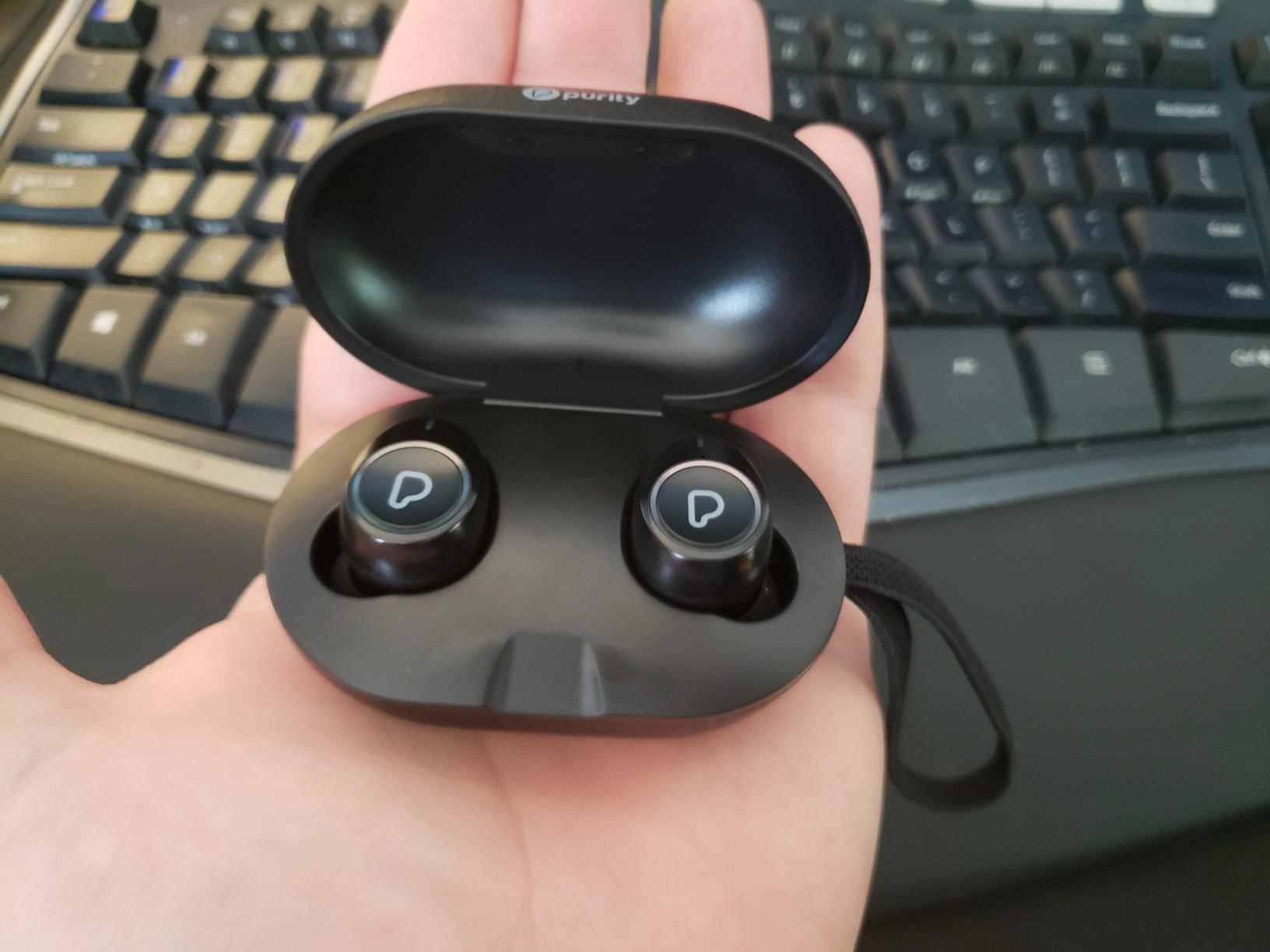 Reviewer holding open case of Purity True Wireless Earbuds