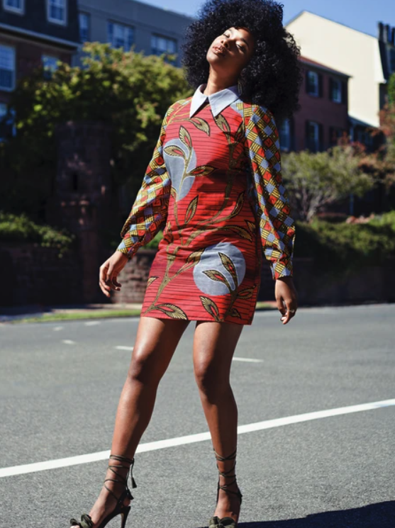 Model wearing the red, blue, and green printed mini dress