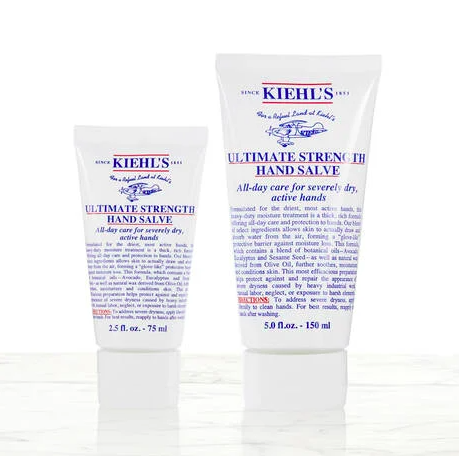 A pair of hand creams on a simple marble counter