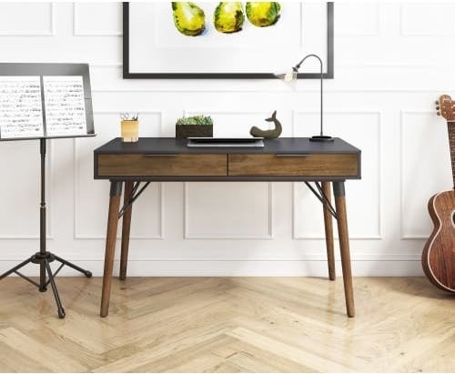 The dark wood writing desk with a black top and two drawers