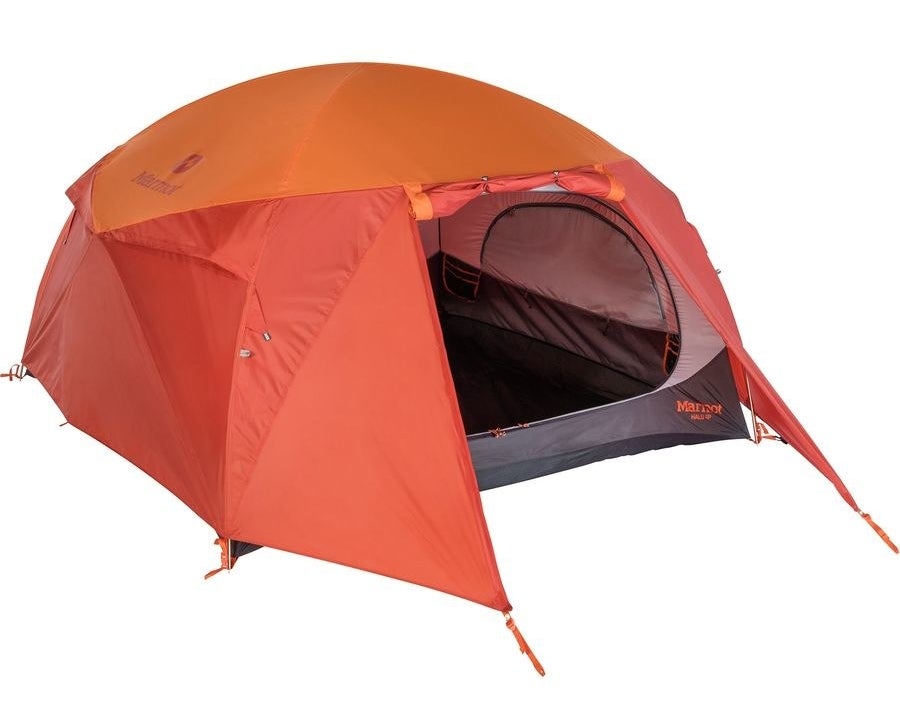 orange and red domed tent with a large zippered door and staked vestibule