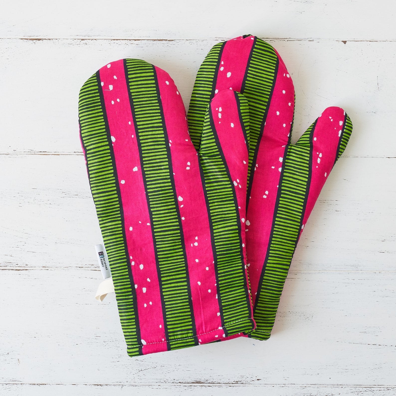 the mittens in pink and green striped print