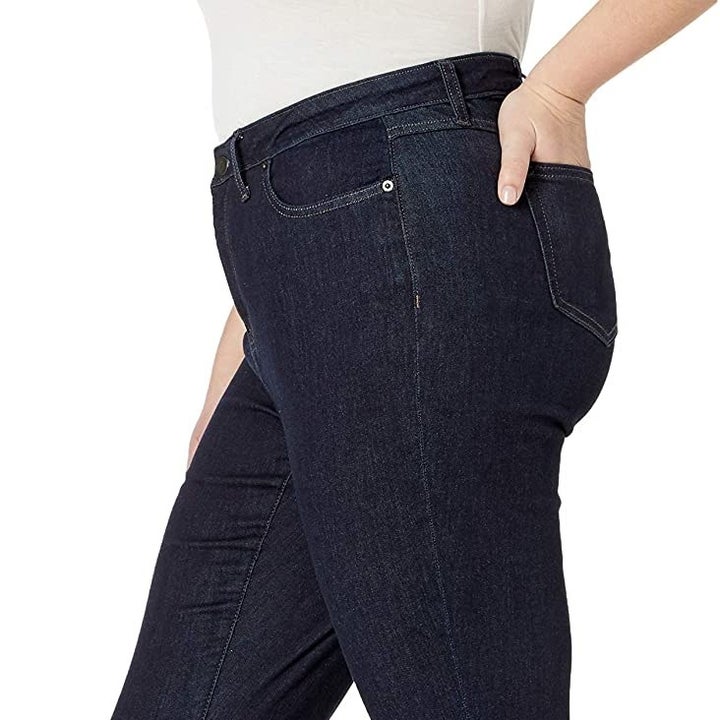 Side view of a model wearing the dark rinse