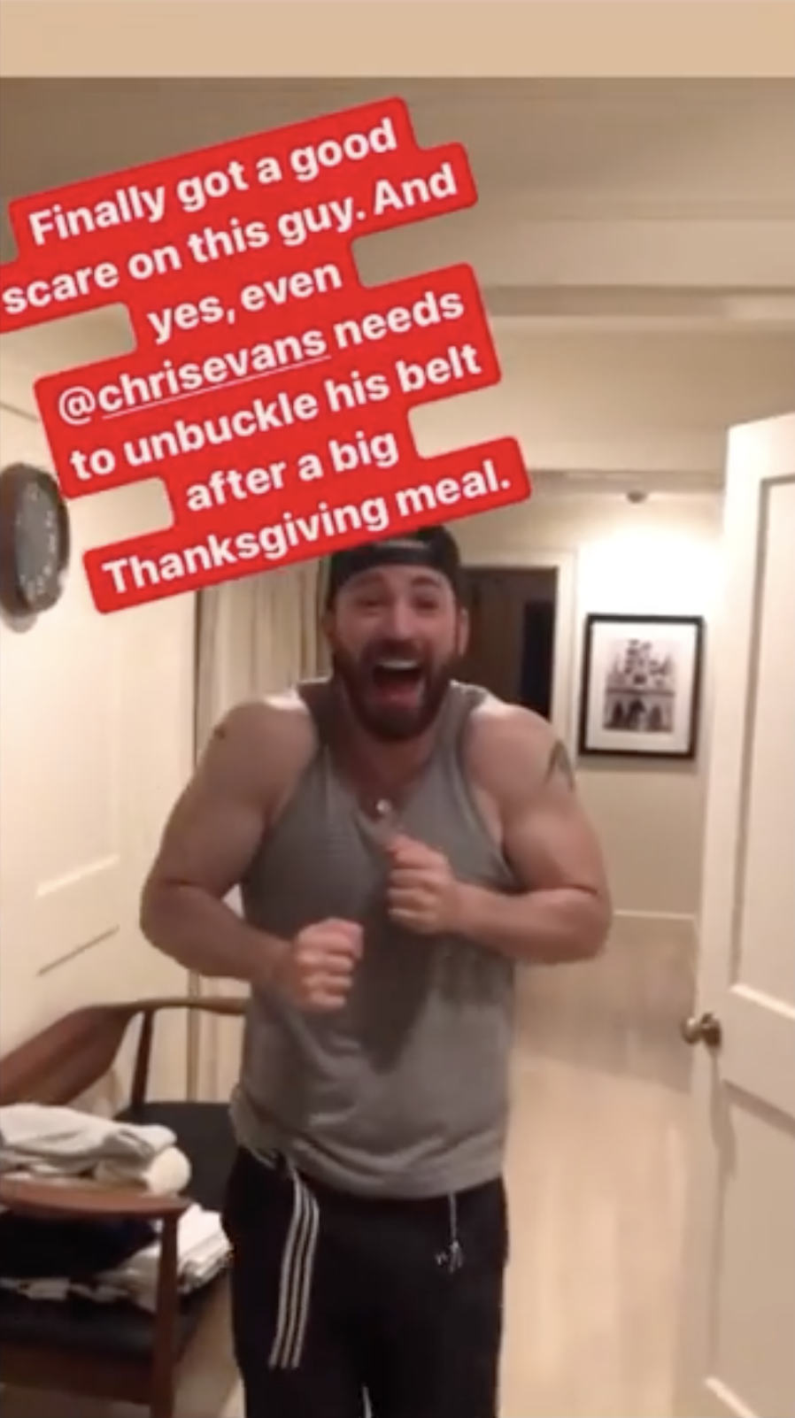 Chris Evans flexing biceps after being surprised by brother Scott Evans