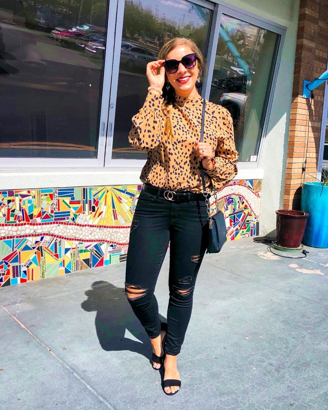 Reviewer wearing the leopard print blouse in tan