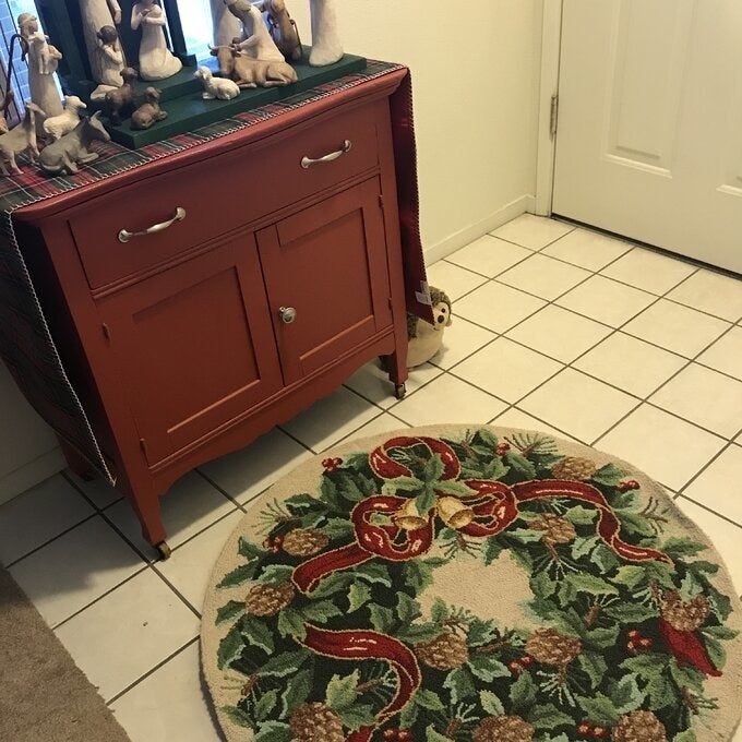 The ivory/green area rug