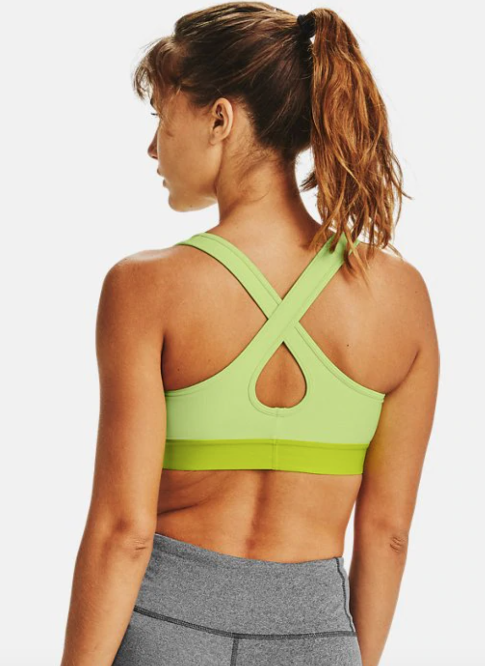 a model in a lime green sports bra