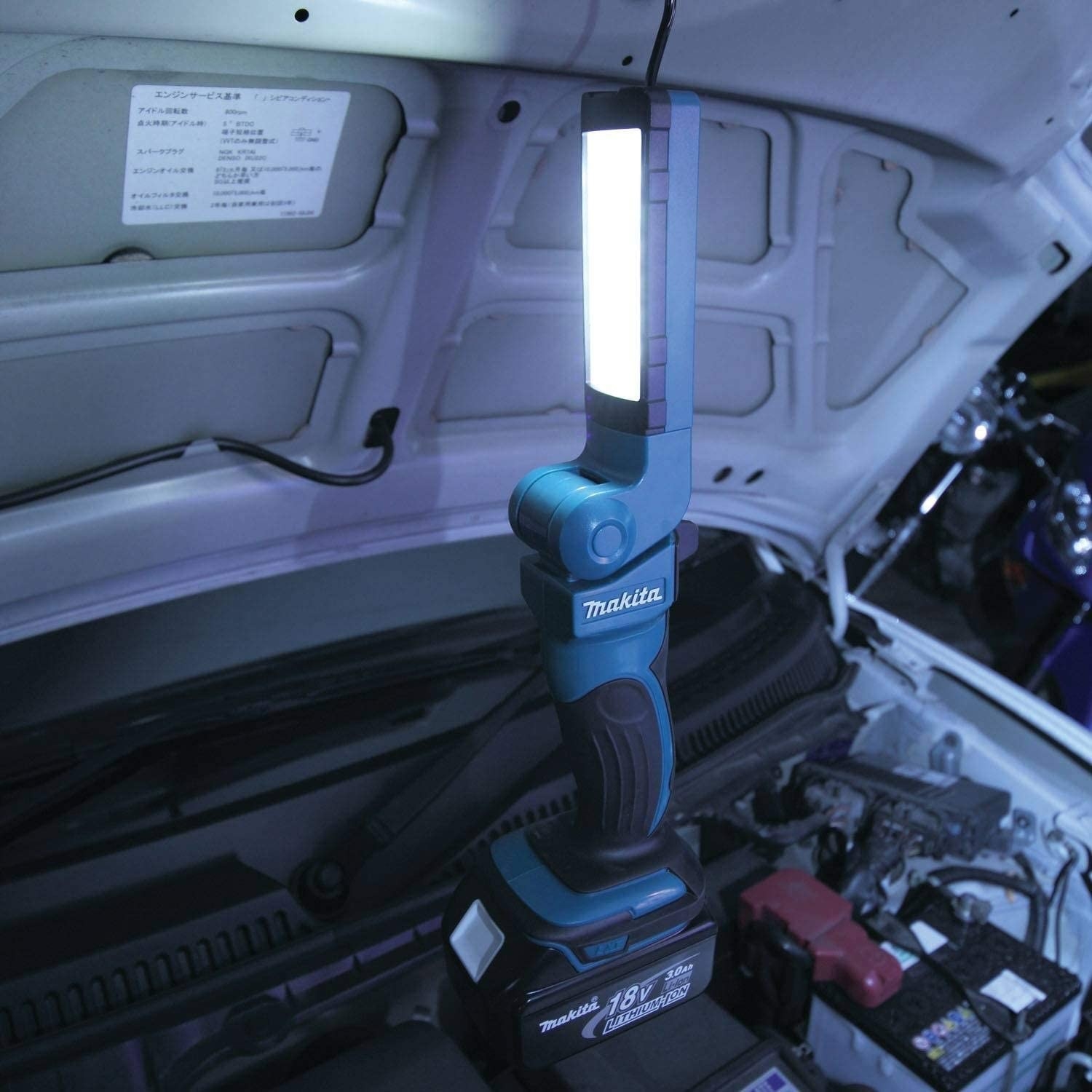 The flashlight in the hood of a car