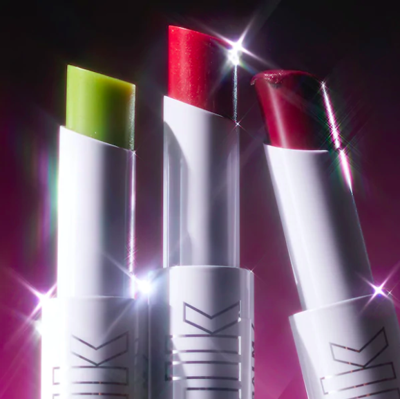 A trio of lip balms with lens flares decorating them