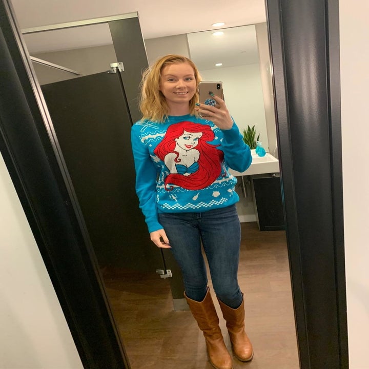 a reviewer in a little mermaid ugly sweater