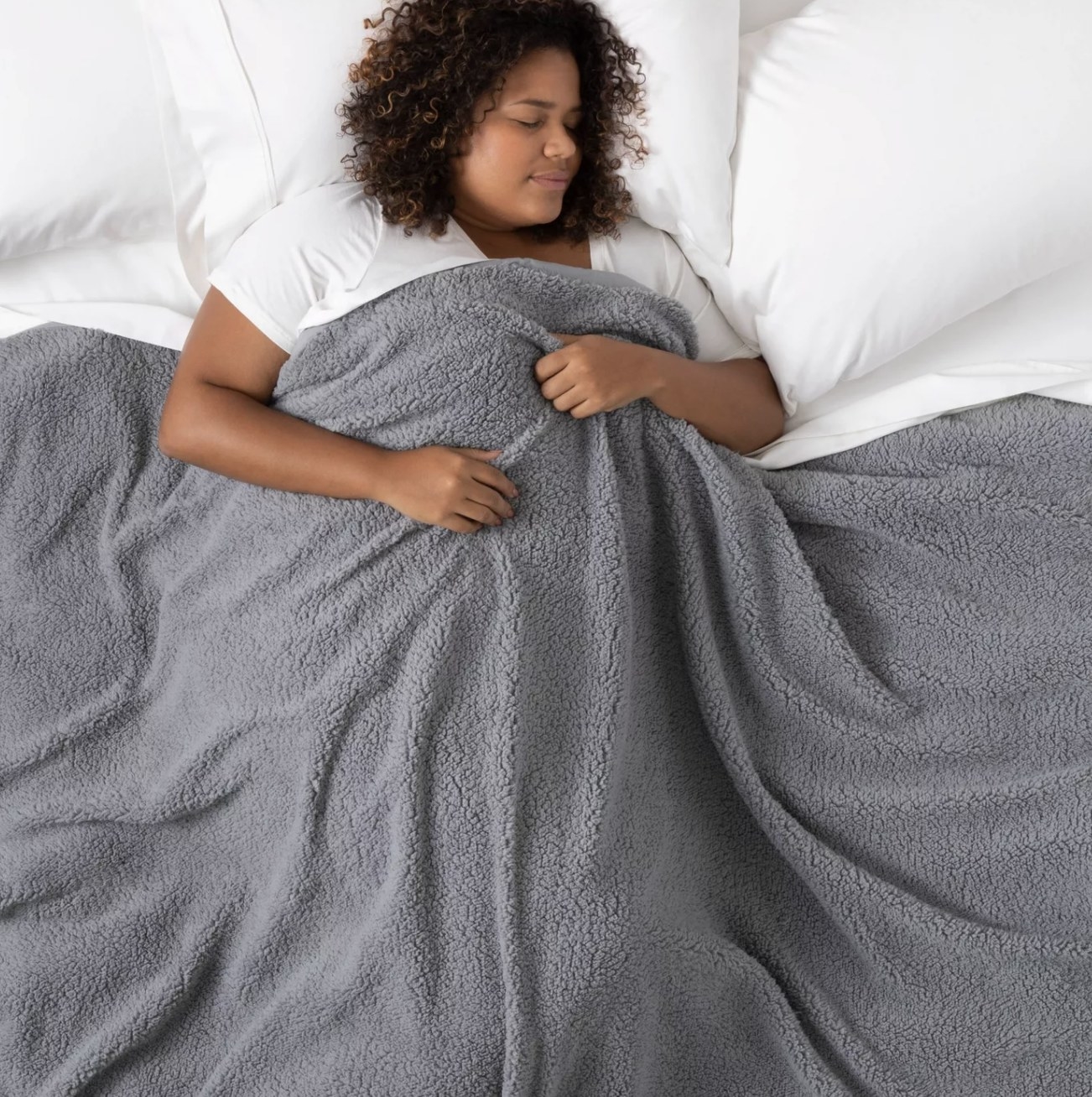 Woman sleeping under the weighted blanket