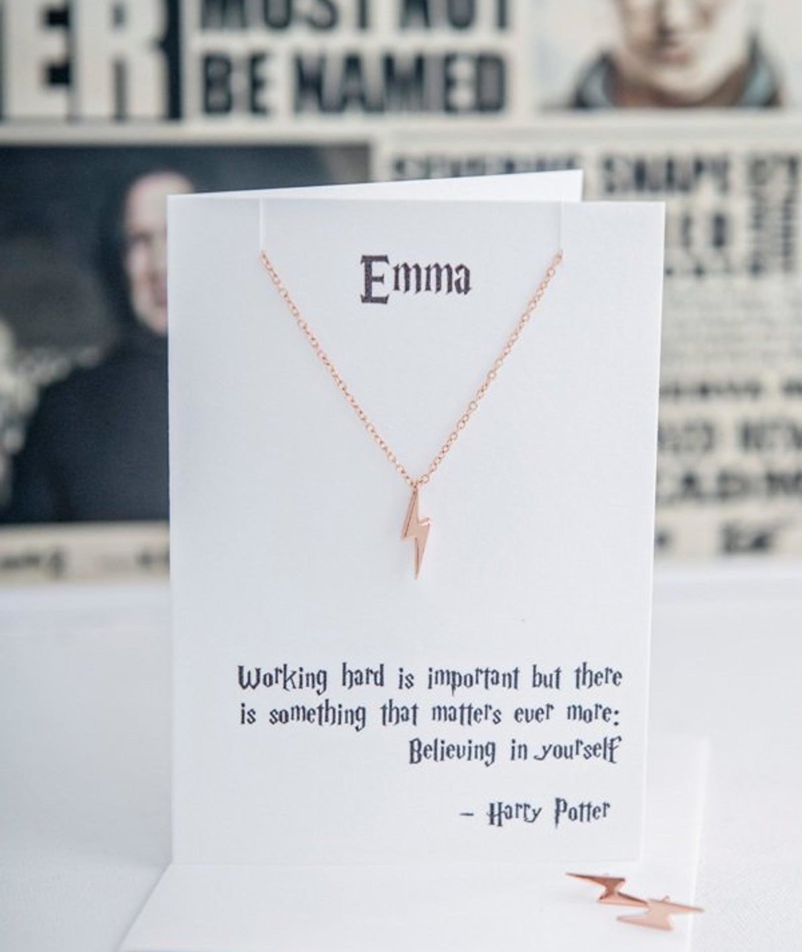 the lightning bolt necklace on a white card with a quote that says &quot;Emma&quot; 