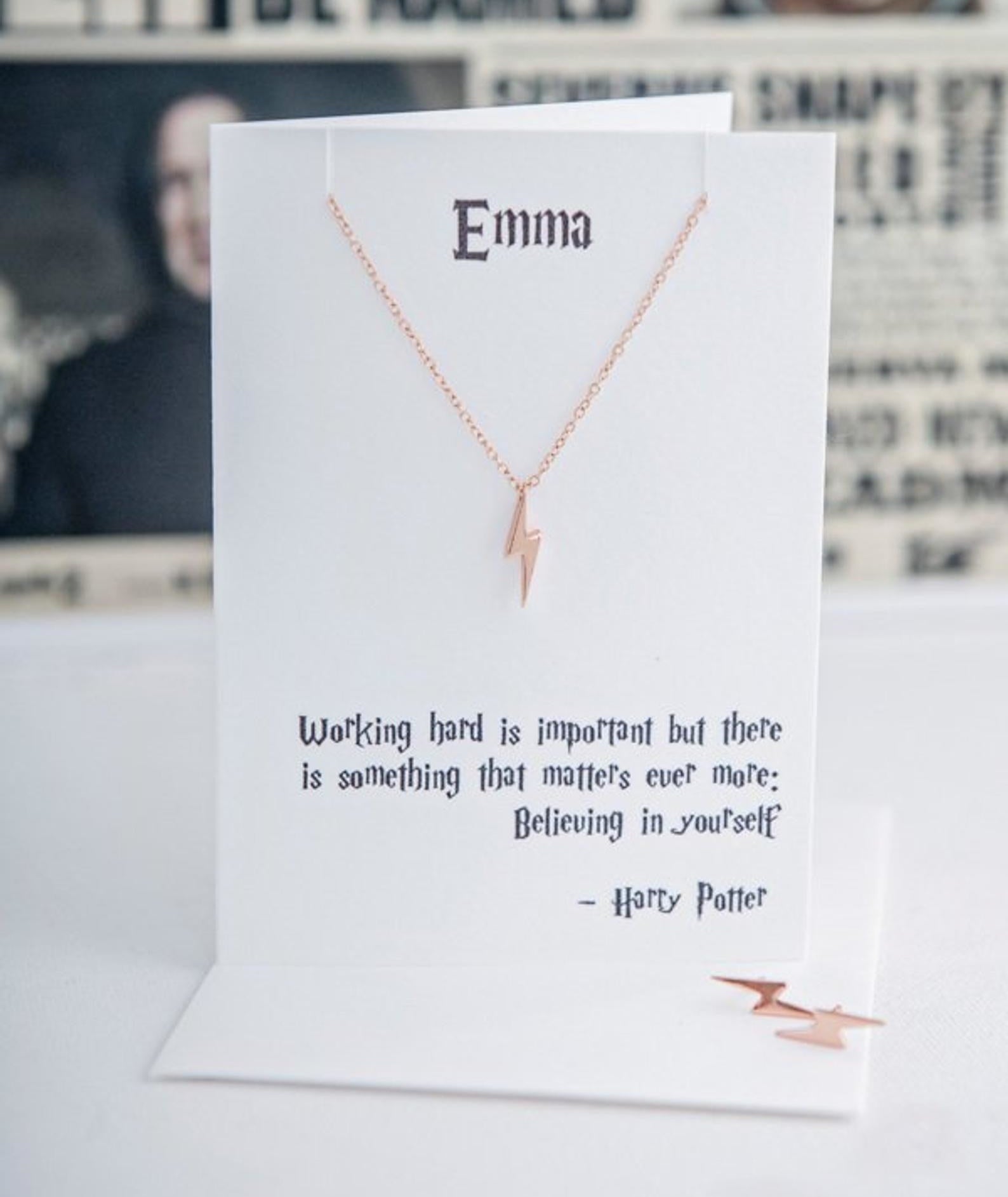 the lightning bolt necklace on a white card with a quote that says &quot;Emma&quot; 