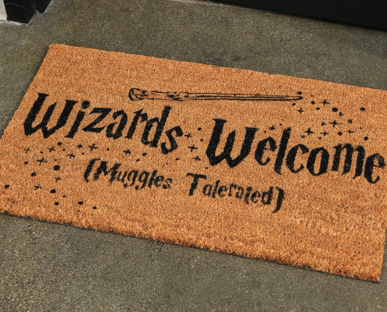 the mat with text "Wizards Welcome (Muggles Tolerated)"
