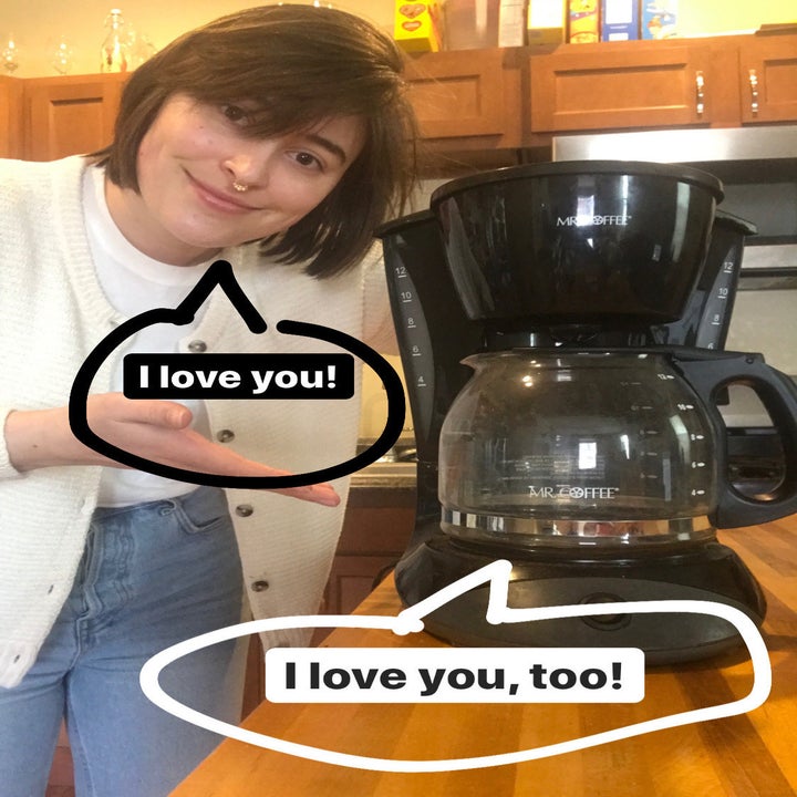 BuzzFeed Shopping reviewer standing with their Mr. Coffee, saying "I love you"