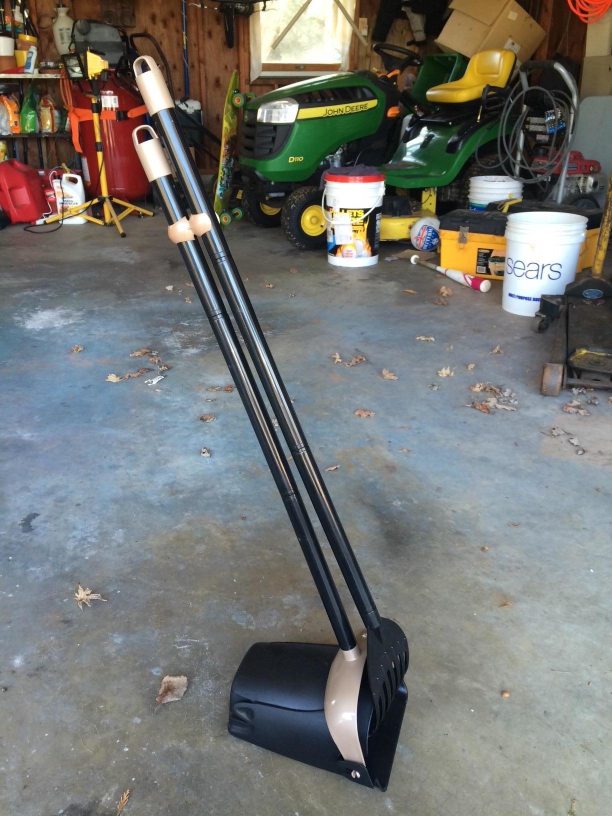 The scooper kit, which has a small bucket on a long swivel handle, and a rake on a similar handle