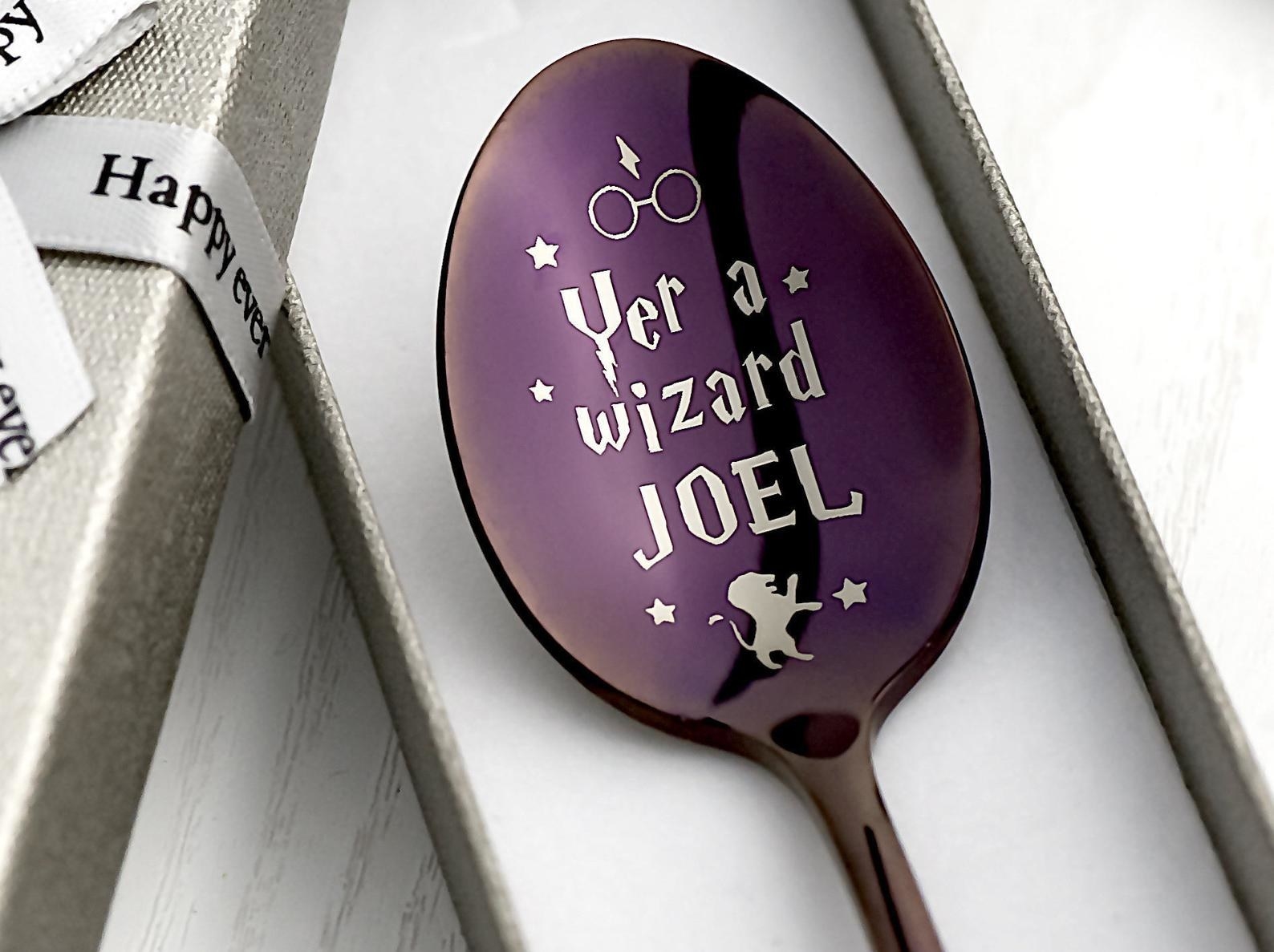 the purple spoon with engraved text that says "yer a wizard Joel"