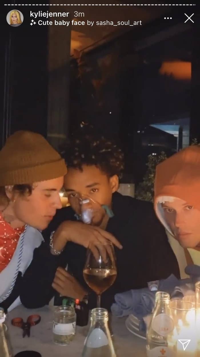 Jaden Smith wearing an oxygen mask while sitting at a table with two guests