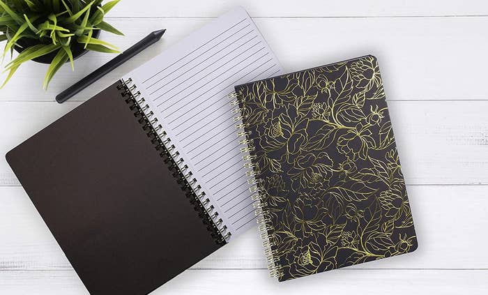 A notebook with a gold foil design