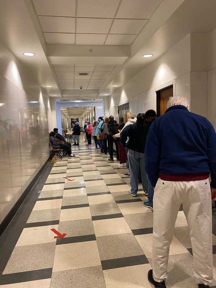 A dozen voters wait in line