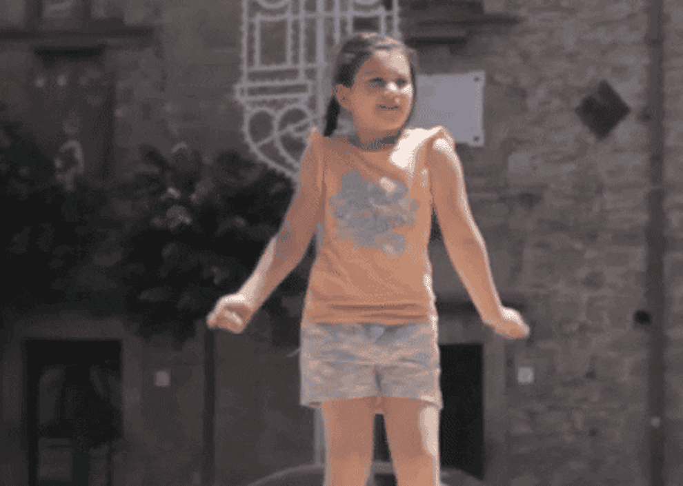 A little girl dances gleefully