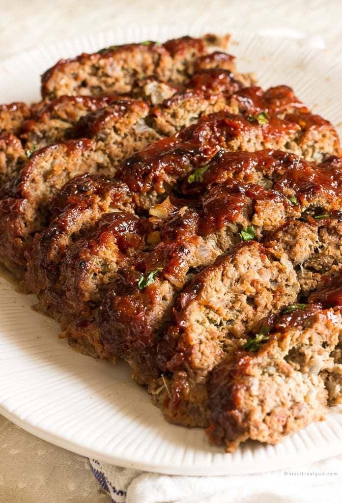 A meatloaf cut into slices on a plate.