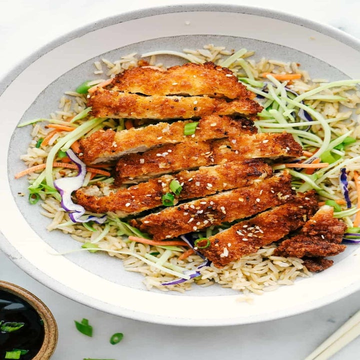 Sliced chicken katsu over rice and broccoli slaw.