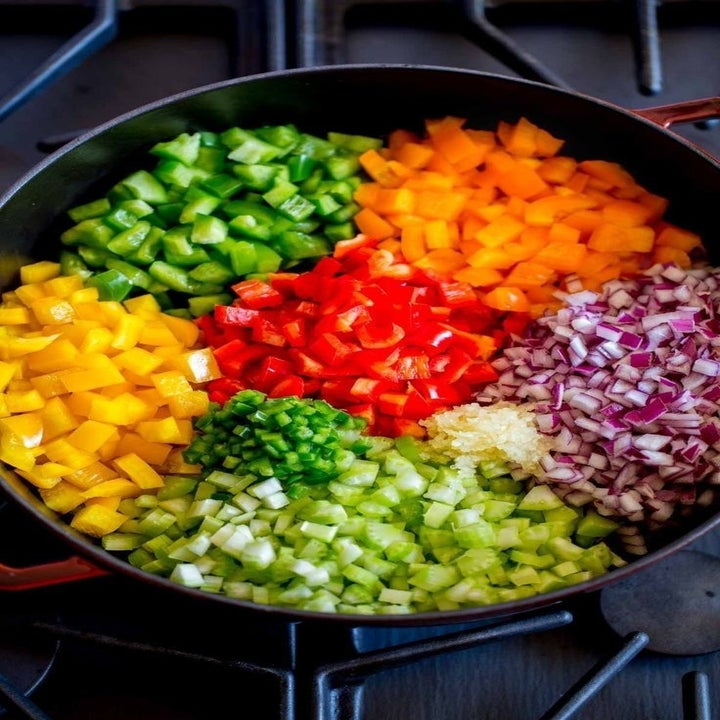 Diced veggies (carrots, celery, onion, peppers) in a skillet.
