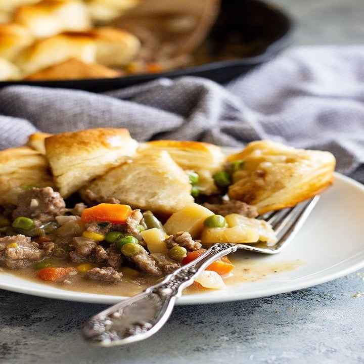 A plate topped with beef pot pie.