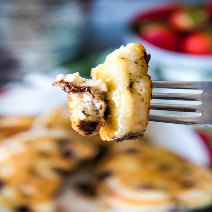 A forkful of a chocolate chip pancake.